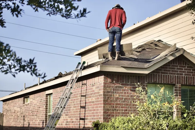 Professional roofer working on a residential roof in Seneca Knolls